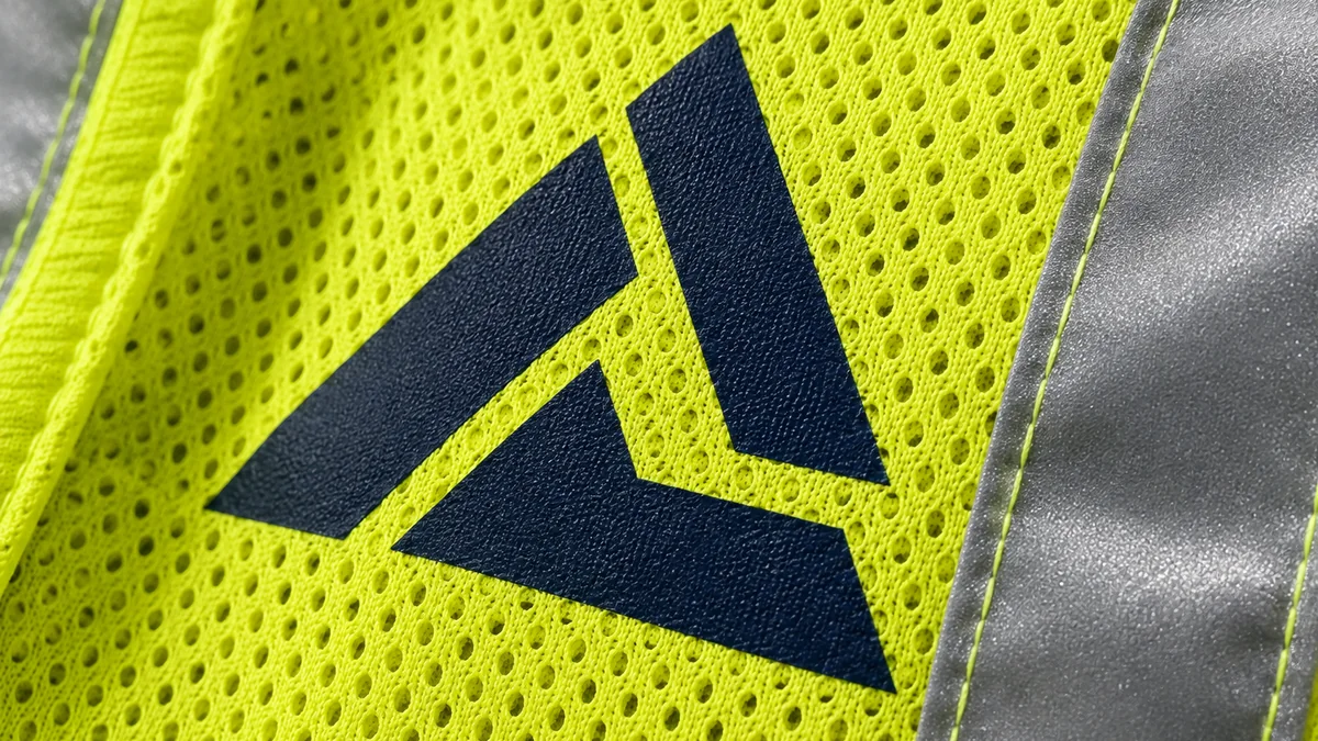 Close-up of a clean logo print on reflective vest fabric